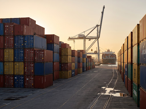 South African Port with shipping containers and industrial crane at dawn